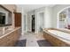 Primary bathroom featuring dual vanities, a soaking tub, and walk-in closet at 6959 Westchester Cir, Bradenton, FL 34202