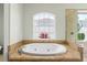 Bathroom featuring a standalone tub with jets and natural lighting at 6959 Westchester Cir, Bradenton, FL 34202