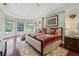 Bright, luxury main bedroom with hard wood flooring and decorative lighting at 6959 Westchester Cir, Bradenton, FL 34202