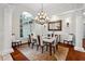 Elegant dining room featuring a modern chandelier and a large window, perfect for entertaining at 6959 Westchester Cir, Bradenton, FL 34202