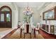 Formal dining room with hardwood floors, large window, chandelier, and sideboard at 6959 Westchester Cir, Bradenton, FL 34202