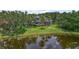 Expansive home with a screened-in pool, lush landscaping, and pond, creating a private, serene retreat at 6959 Westchester Cir, Bradenton, FL 34202