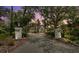 Grand estate with manicured landscaping, a circular driveway, and elegant entrance pillars at 6959 Westchester Cir, Bradenton, FL 34202
