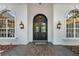 Elegant home entrance with double doors, arched windows, and updated lighting at 6959 Westchester Cir, Bradenton, FL 34202