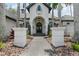 Front entrance with stone pathway and columns, leading to a dark-stained front door at 6959 Westchester Cir, Bradenton, FL 34202
