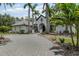 Elegant front exterior showing the circular driveway and detailed landscaping at 6959 Westchester Cir, Bradenton, FL 34202