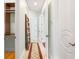 Hallway with neutral walls, white trim, and doors, leading to various rooms within the home at 6959 Westchester Cir, Bradenton, FL 34202