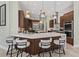 Beautiful kitchen featuring a large quartz island with barstool seating and modern pendant lighting at 6959 Westchester Cir, Bradenton, FL 34202