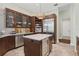 Modern kitchen features custom cabinetry, stainless steel appliances, and a center island with beverage cooler at 6959 Westchester Cir, Bradenton, FL 34202
