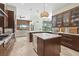 Modern kitchen featuring stainless steel appliances, pendant lighting, and a kitchen island with a beverage fridge at 6959 Westchester Cir, Bradenton, FL 34202