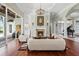 Elegant living room featuring a fireplace, hardwood floors, and a chandelier with natural light streaming in at 6959 Westchester Cir, Bradenton, FL 34202