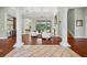 Bright living room with hardwood floors, columns, fireplace and view of the pool at 6959 Westchester Cir, Bradenton, FL 34202
