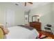 Comfortable main bedroom with hardwood floors, a dresser, and access to an en-suite bathroom at 6959 Westchester Cir, Bradenton, FL 34202