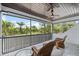 Inviting screened patio with wood ceiling, ceiling fan, and comfortable seating overlooking lush landscaping at 6959 Westchester Cir, Bradenton, FL 34202