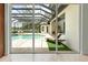 Spacious screened-in pool area with chaise lounge and lush greenery at 6959 Westchester Cir, Bradenton, FL 34202