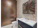 Chic powder room with a stylish mirror, contemporary vanity and tiled accent wall at 6959 Westchester Cir, Bradenton, FL 34202