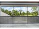 This screened-in porch offers picturesque views of the lush backyard with a pool and surrounding nature at 6959 Westchester Cir, Bradenton, FL 34202