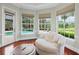 Cozy sitting area with large windows, comfortable seating, and a tranquil view of the pool and backyard at 6959 Westchester Cir, Bradenton, FL 34202