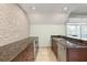 Stylish wet bar with stone accent wall, granite countertops, stainless steel appliances, and ample cabinetry at 6959 Westchester Cir, Bradenton, FL 34202