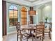 Dining room featuring arched windows and a modern chandelier at 7037 Brier Creek Ct, Lakewood Ranch, FL 34202