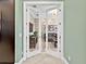 The entryway opens to a living area with stylish wallpaper and neutral color palette at 7037 Brier Creek Ct, Lakewood Ranch, FL 34202