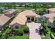 Expansive single-story home featuring a tile roof, brick driveway, and mature landscaping at 7037 Brier Creek Ct, Lakewood Ranch, FL 34202