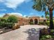 Well maintained single-story home with a tile roof, arched entryway, and a brick driveway at 7037 Brier Creek Ct, Lakewood Ranch, FL 34202