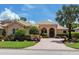 Well maintained single-story home with a tile roof, arched entryway, and a brick driveway at 7037 Brier Creek Ct, Lakewood Ranch, FL 34202