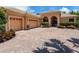 Well maintained single-story home with a tile roof, arched entryway, and a brick driveway at 7037 Brier Creek Ct, Lakewood Ranch, FL 34202