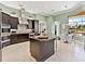 Open kitchen with a large island, stainless steel appliances, and casual dining area at 7037 Brier Creek Ct, Lakewood Ranch, FL 34202