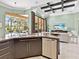 Modern kitchen features granite countertops, stainless steel appliances, and views of the outdoor pool area at 7037 Brier Creek Ct, Lakewood Ranch, FL 34202