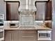 Close-up of modern kitchen with granite countertops, stainless steel appliances, and stylish backsplash at 7037 Brier Creek Ct, Lakewood Ranch, FL 34202