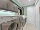 Well-organized laundry room with storage cabinets, counters, and stainless steel appliances at 7037 Brier Creek Ct, Lakewood Ranch, FL 34202