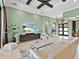 Stylish living room showcases neutral tones, tile floors, and a large entertainment center at 7037 Brier Creek Ct, Lakewood Ranch, FL 34202