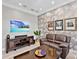 The living room has comfortable seating and a mounted TV for relaxing and entertaining at 7037 Brier Creek Ct, Lakewood Ranch, FL 34202