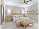 Comfortable main bedroom with a ceiling fan, two side tables, and ensuite access at 7037 Brier Creek Ct, Lakewood Ranch, FL 34202