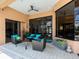 Covered patio with comfortable seating, ceiling fan, and stylish décor, creating a cozy outdoor living space at 7037 Brier Creek Ct, Lakewood Ranch, FL 34202