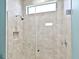 Modern walk-in shower featuring tiled walls, glass door, and chrome fixtures, a sleek and luxurious design at 7037 Brier Creek Ct, Lakewood Ranch, FL 34202