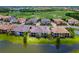 An aerial view of the condo building showing the surrounding golf course and nearby waterway at 7387 Divot Loop # 15-D, Lakewood Ranch, FL 34202