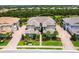A beautiful aerial view of the condos featuring lush landscaping, lake views, and a well-maintained community at 7387 Divot Loop # 15-D, Lakewood Ranch, FL 34202