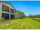 Beautiful backyard view with a screened lanai and a scenic pond backdrop at 7387 Divot Loop # 15-D, Lakewood Ranch, FL 34202