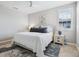 Cozy bedroom with natural light, queen bed, and decorative rug at 7387 Divot Loop # 15-D, Lakewood Ranch, FL 34202