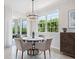 Cozy dining area with natural light, modern lighting, and balcony access at 7387 Divot Loop # 15-D, Lakewood Ranch, FL 34202