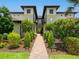Attractive condo with lush landscaping, a brick pathway, and well-maintained green lawns at 7387 Divot Loop # 15-D, Lakewood Ranch, FL 34202