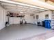Spacious garage with epoxy flooring, shelving units, storage and access to water heater at 7387 Divot Loop # 15-D, Lakewood Ranch, FL 34202