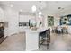 Kitchen with island and bar stools that transitions to the dining room at 7387 Divot Loop # 15-D, Lakewood Ranch, FL 34202