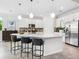 Modern kitchen features an island with bar seating, stainless steel appliances, and ample counter space at 7387 Divot Loop # 15-D, Lakewood Ranch, FL 34202
