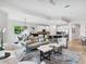 Bright living area boasts an open-concept layout with sleek furnishings and balcony access at 7387 Divot Loop # 15-D, Lakewood Ranch, FL 34202