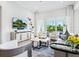 Open living room boasts large windows and sliding doors to a balcony, filling the space with natural light at 7387 Divot Loop # 15-D, Lakewood Ranch, FL 34202