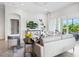 Open living room features a tv and balcony access, providing a seamless indoor-outdoor flow at 7387 Divot Loop # 15-D, Lakewood Ranch, FL 34202